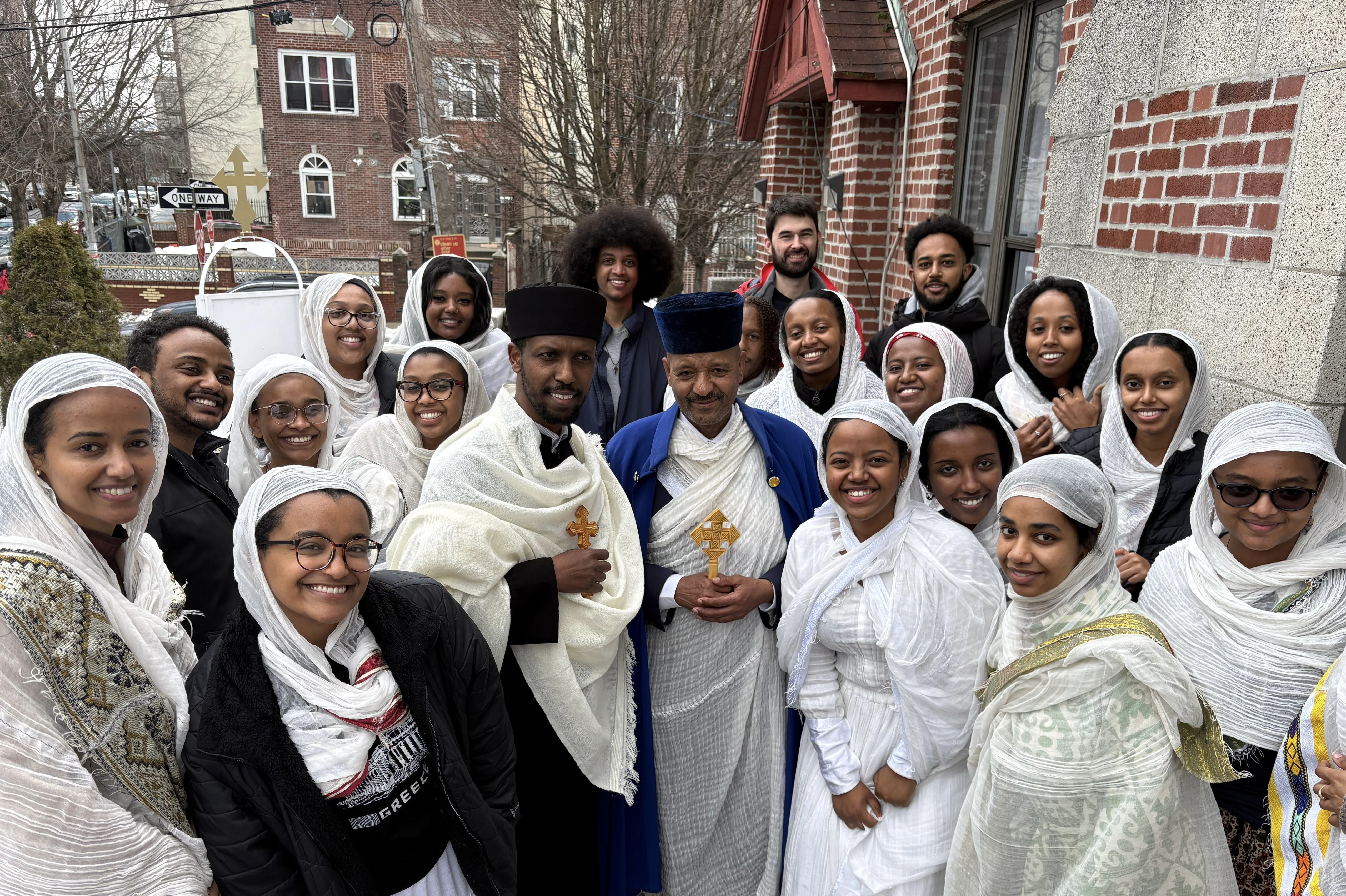 OTY NYC members gather with clergy outside the church after a Lenten liturgy